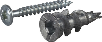 Gipsankare och skruv i metall på grå yta.