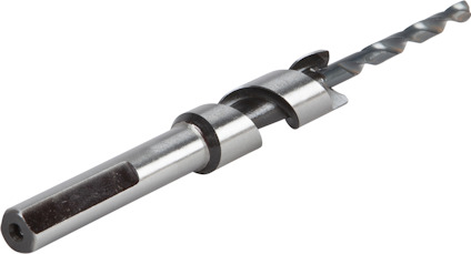 Metallborr med spiralformad borrspets och skaft, liggande på en ljus yta.