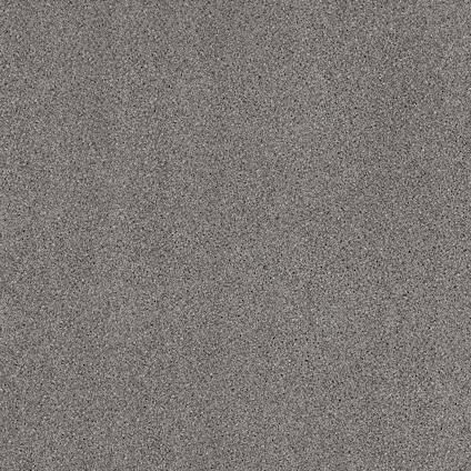 Gråmelerad yta med små fläckar i olika nyanser, vilket ger en texturerad, stenliknande utseende.