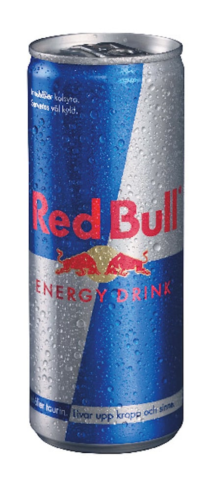 Energidryck Red Bull i en blå och silverfärgad burk med röd text och logotyp. Burken har kondensdroppar.