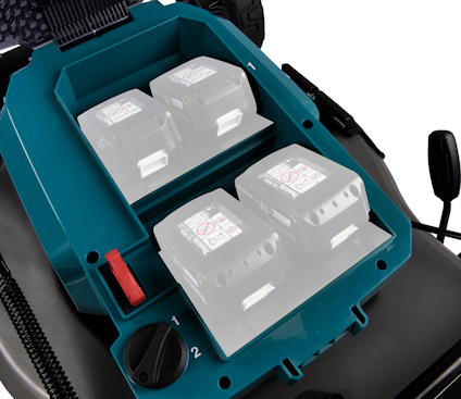 Närbild på en blå batterifack med fyra batteriplatser märkta 1 och 2. Svart reglage och röd knapp synliga.
