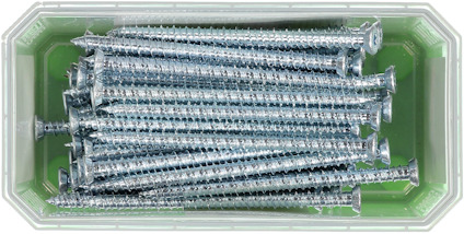 En låda med flera metallskruvar på en grön botten.